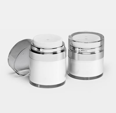 Two white airless jar have been placed in white background， one is open.